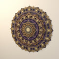 A close-up angled view of the multi-layered circular mandala wall art featuring intricate geometric and celestial patterns in gold and plum tones.