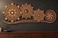A large multi-layered wooden celestial mandala wall art piece mounted on a dark grey wall above a dark wood cabinet.