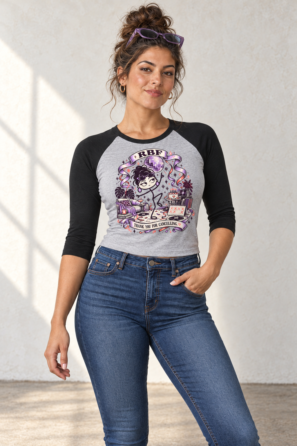 Lifestyle mockup: Thank You for Cancelling 3/4 raglan baby tee in Athletic Heather and Black. Studio portrait with the front design visible.