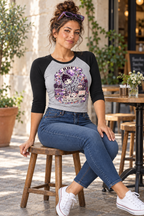 Lifestyle mockup: Thank You for Cancelling 3/4 raglan baby tee in Athletic Heather and Black. Seated at a cafe with the front design visible.